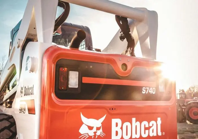 Rear view of a Bobcat S740 skid steer loader with sunlight flare, part of Forklift Guy’s Calgary, AB equipment fleet