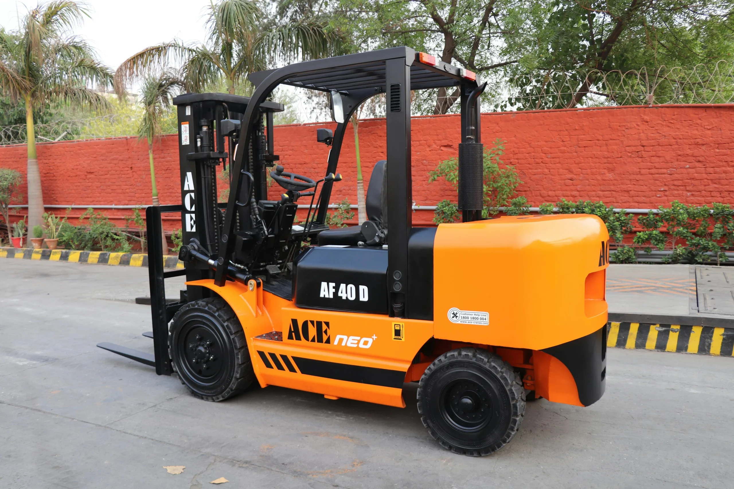 Bright orange forklift parked near greenery in Calgary for sale