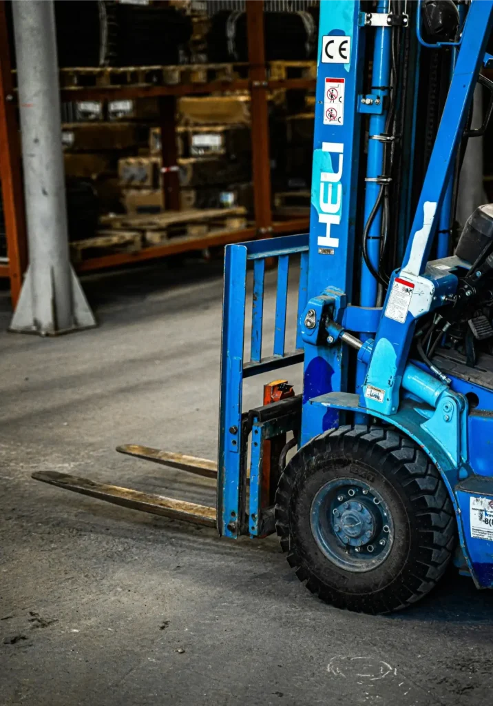Blue HELI forklift positioned in a Calgary warehouse aisle, available through Forklift Guy for sale or rental — forklift services calgary