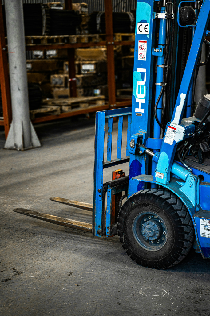 Blue HELI forklift parked inside a warehouse in Calgary, AB